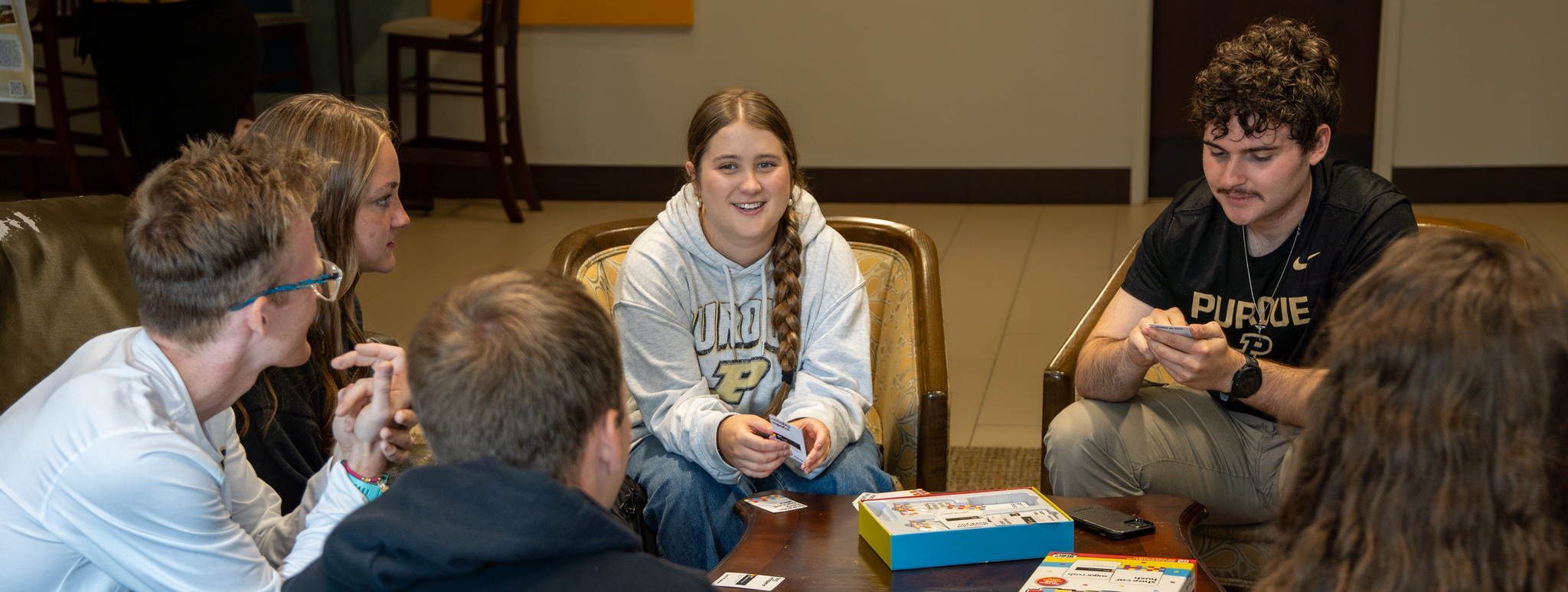 students sitting around a table playing a card game